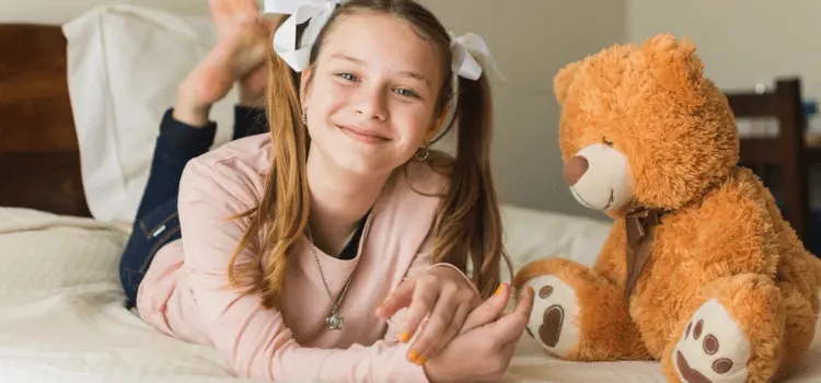 A smiling lady with stuffed Animal